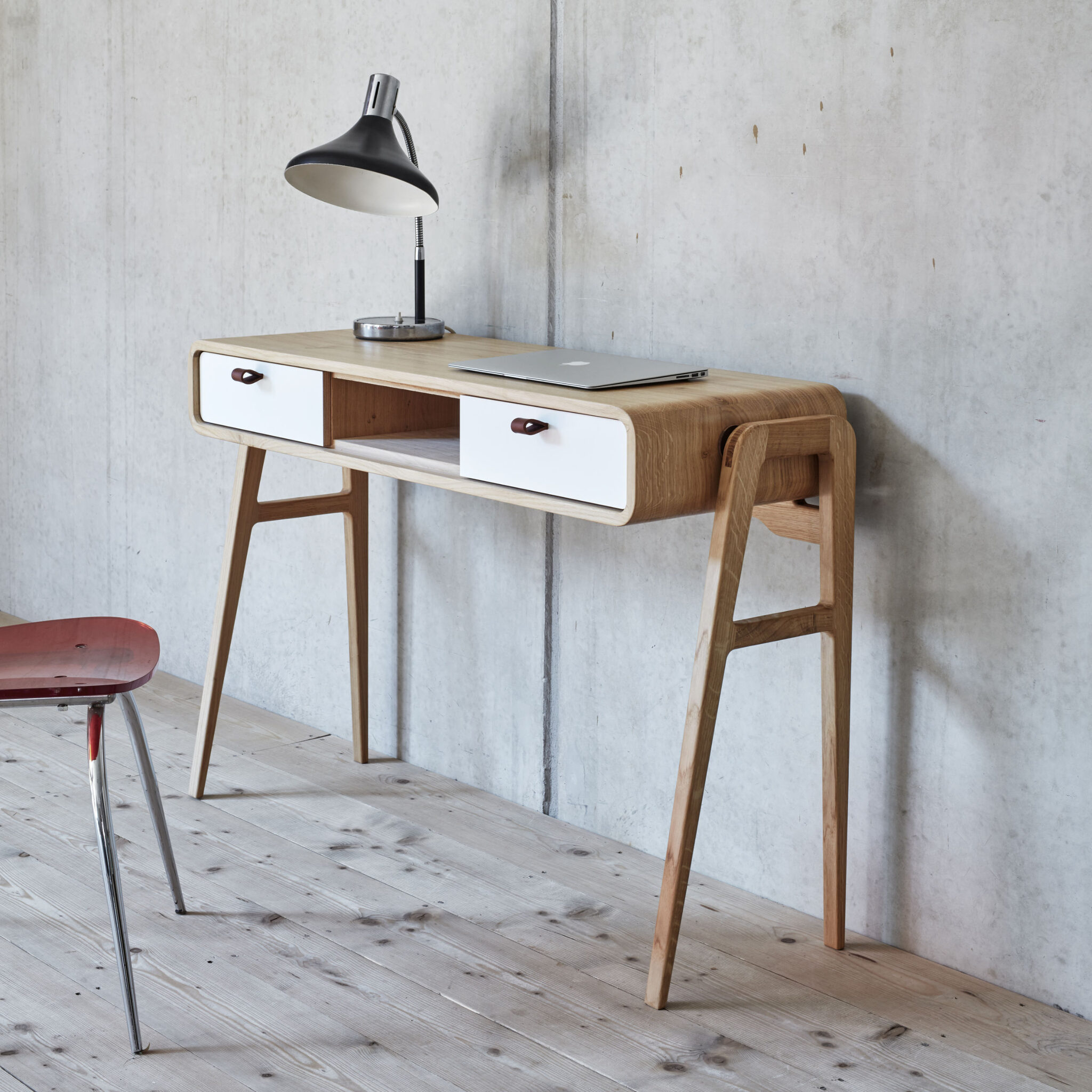 Workspace with white-fronted nm13H desk, red chair, concrete wall and wood floor. nordlys møbler: HANDMADE - SCANDINAVIAN - FURNITURE from Norwegian oak.