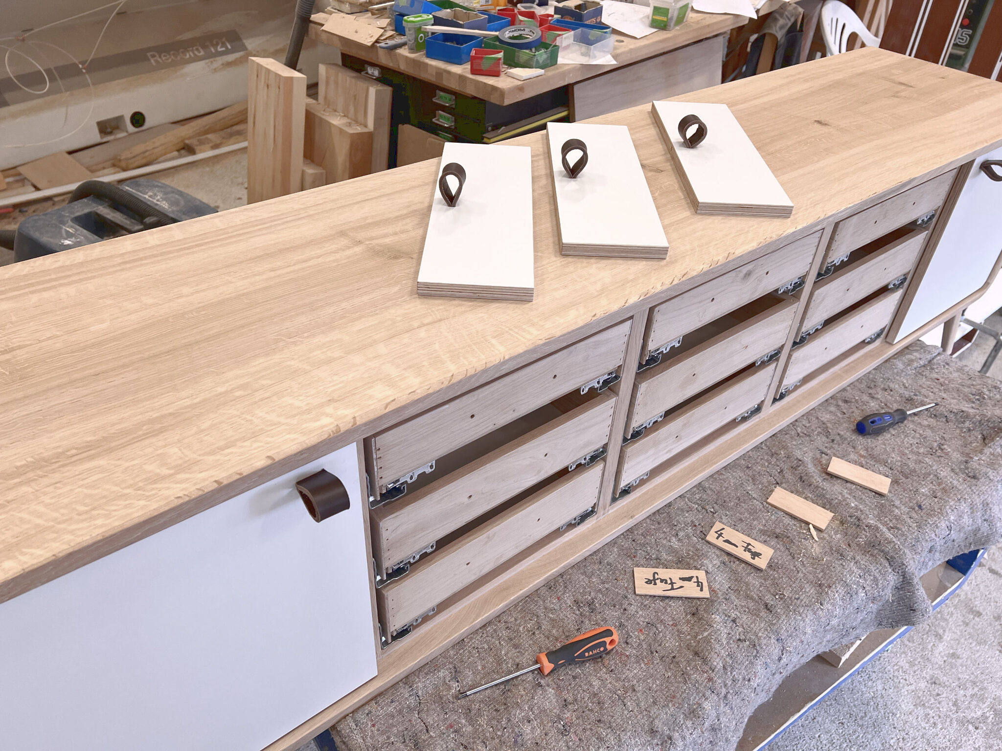 Workshop assembly of the large nm35L sideboard with white fronts. nordlys møbler: HANDMADE - SCANDINAVIAN - FURNITURE from Norwegian oak.