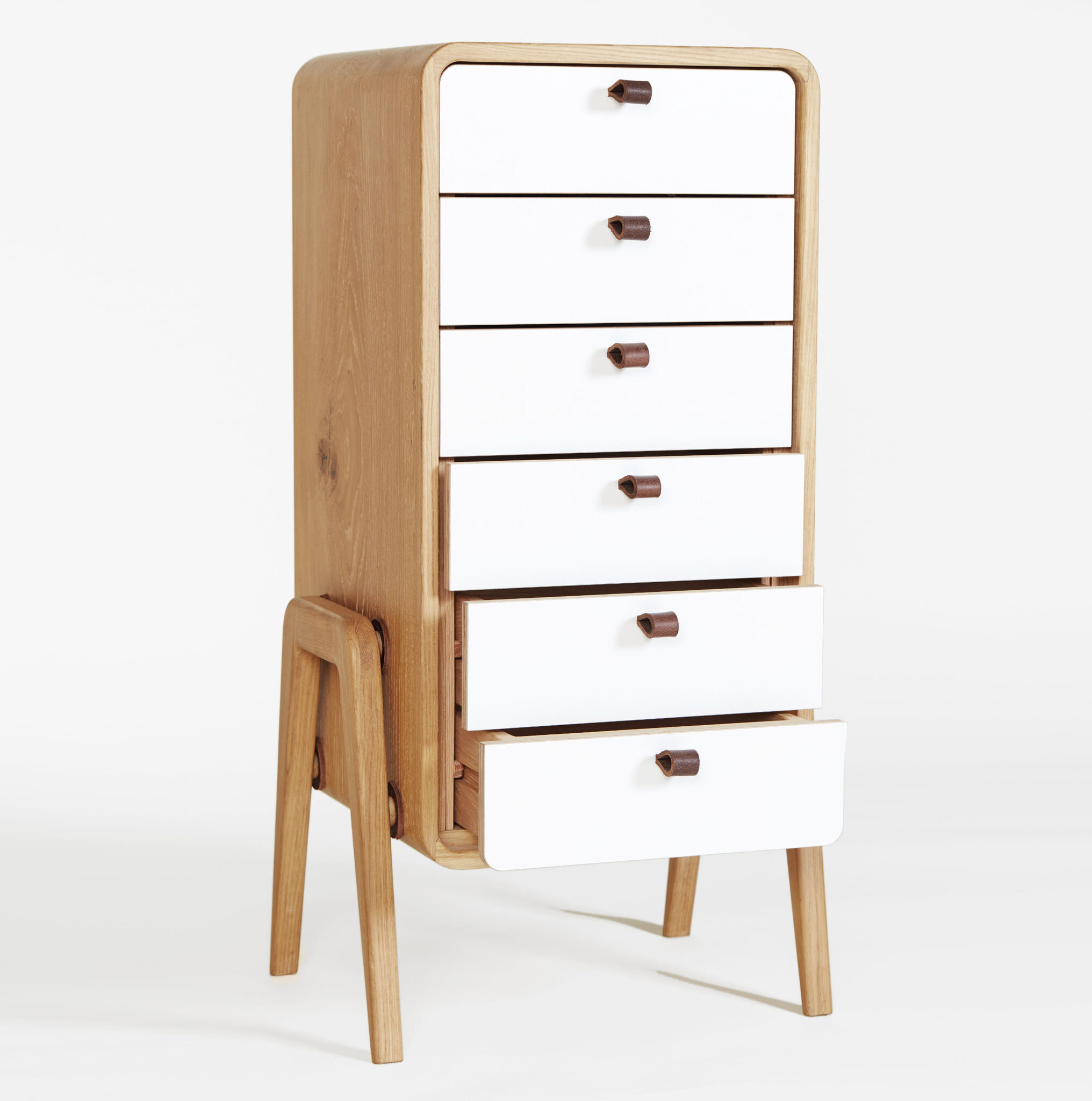 White-fronted nm61L cabinet highlighting open drawers and leather handles in a studio. nordlys møbler: HANDMADE - SCANDINAVIAN - FURNITURE from Norwegian oak.